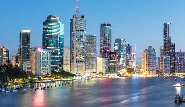 a city skyline with a body of water