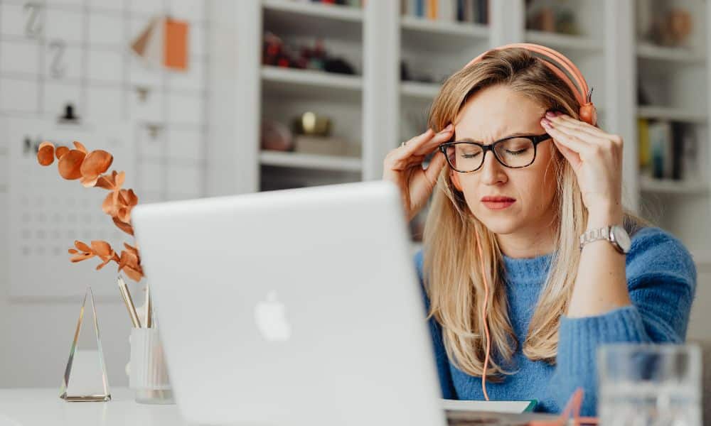Woman frustrated with laptop performance.