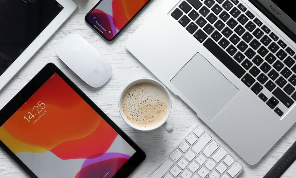 Apple devices and coffee on table