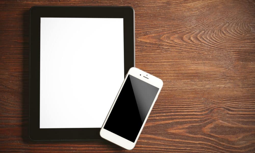 Tablet and smartphone on wooden surface