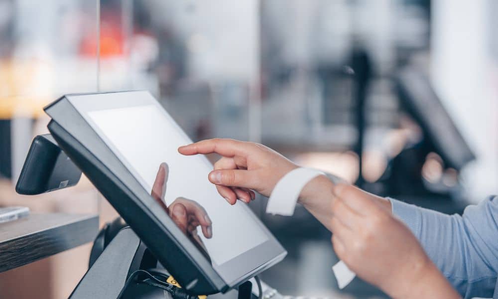 Customer interacting with touchscreen register