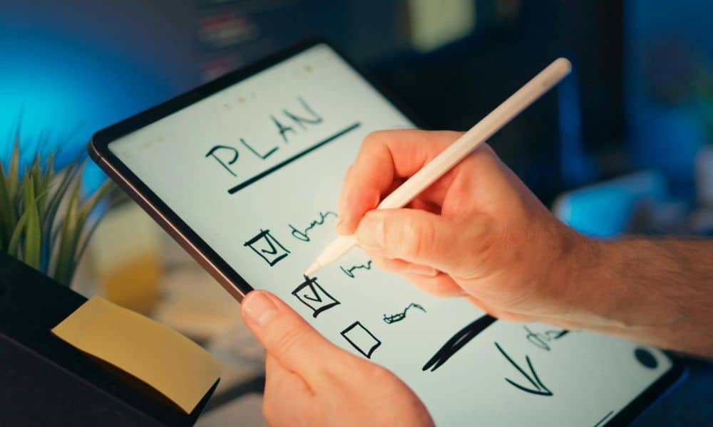 Hand writing checklist on tablet